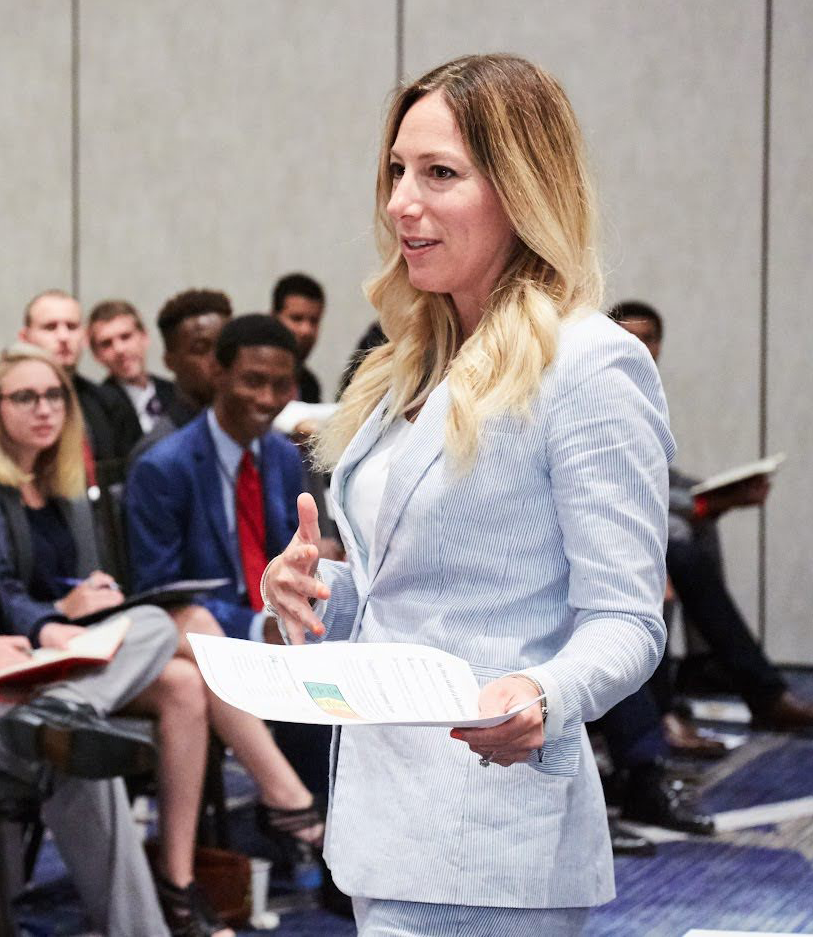 Melissa White Boyer speaking on stage about resilience, leadership, and personal growth during a keynote event.